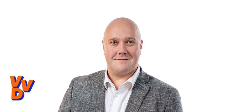 Portretfoto Thierry Aartsen met partijlogo VVD