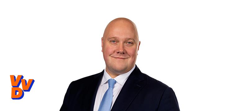 Portretfoto Thierry Aartsen met partijlogo VVD