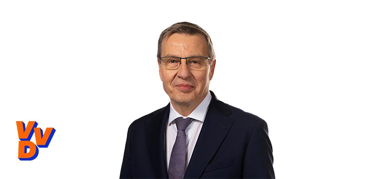 Portretfoto Harry Bevers met partijlogo VVD
