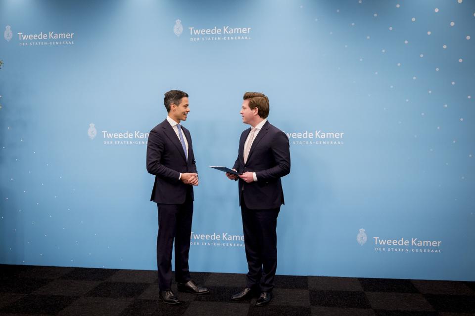 Voor een lichtblauwe achterwand staan formateur Jetten (links) en Kamervoorzitter Thom van Campen. Van Campen heeft het eindverslag in zijn handen. 